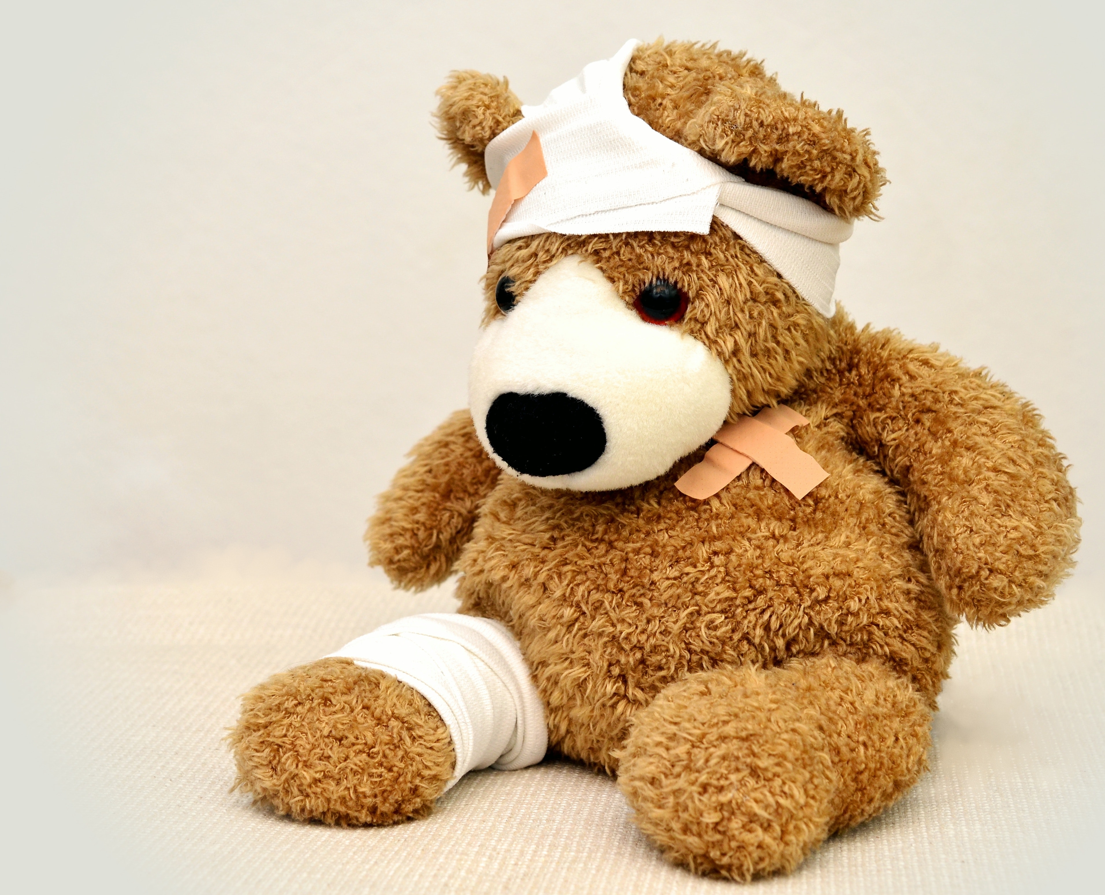 brown plush bear with bandages